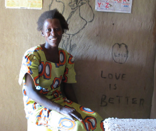 A GiveDirectly cash transfer recipient in her home. (Photo courtesy of GiveWell)